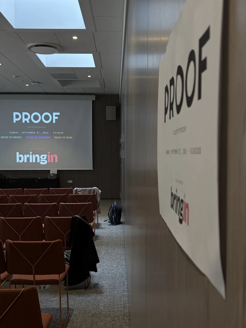 Rows of seats and the PROOF poster